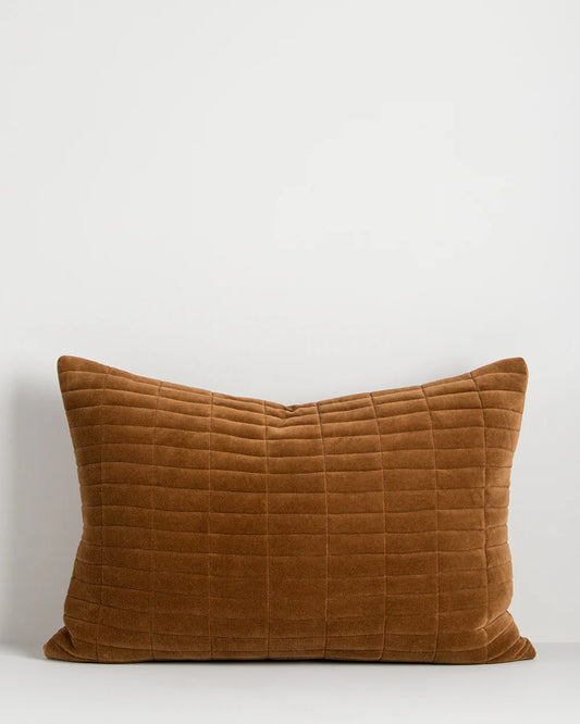 Brown quilted cushion on a white background
